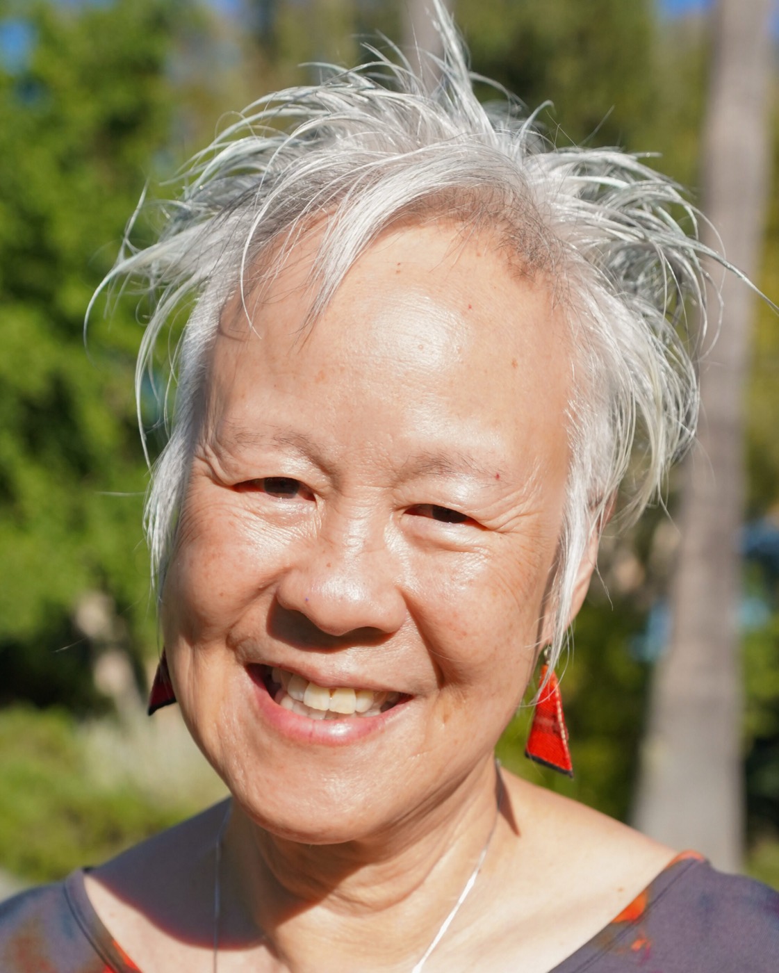 Nina Lau-Branson, smiling, outdoors in warm afternoon light